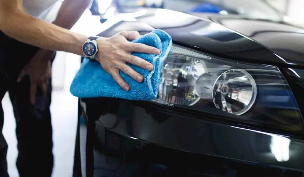 Step-by-step hand polishing car headlights using microfiber cloths and UV protectant at home.