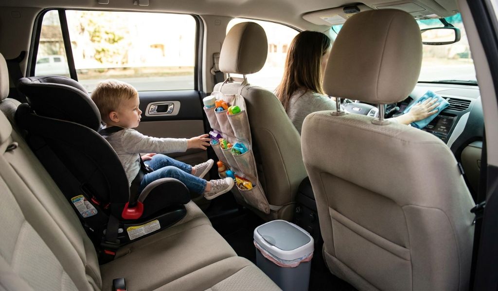 Microfiber cloth wiping down a car dashboard