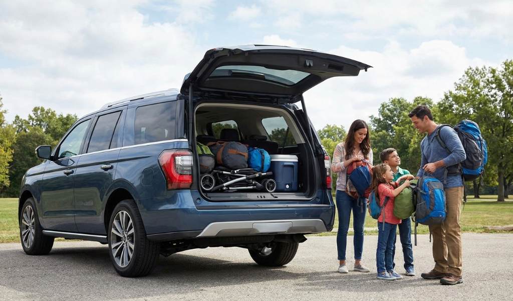 Minivan cargo area loaded with luggage and sports gear